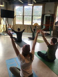 a group of people doing yoga in a room
