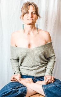 a woman meditating in a lotus pose
