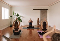 a group of women practicing yoga in a room
