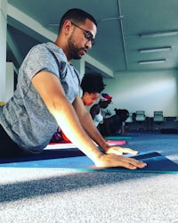 a group of people doing yoga in a room