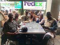 a group of people sitting at a table in a restaurant
