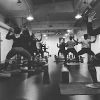 a group of people doing yoga in a room