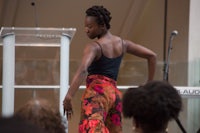 a woman is dancing on stage in front of an audience