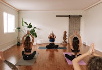 a group of women practicing yoga in a room