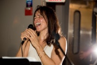 a woman singing into a microphone